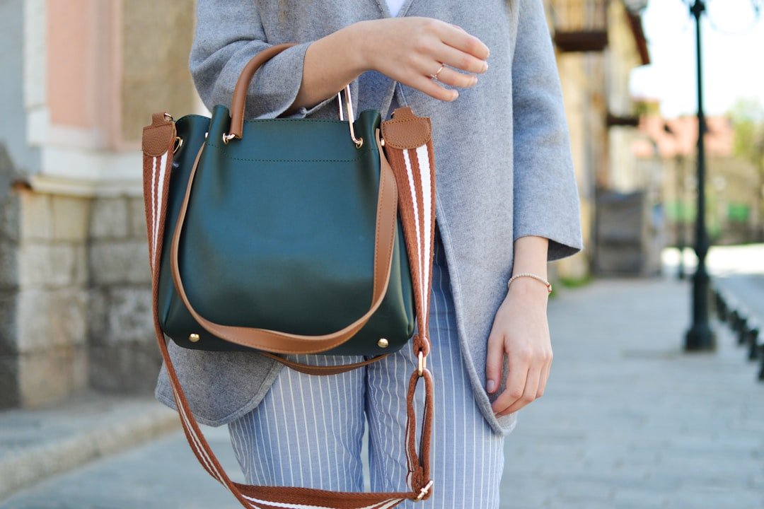 Illustration of suede handbag styling; generic image, not a specific The RealReal product