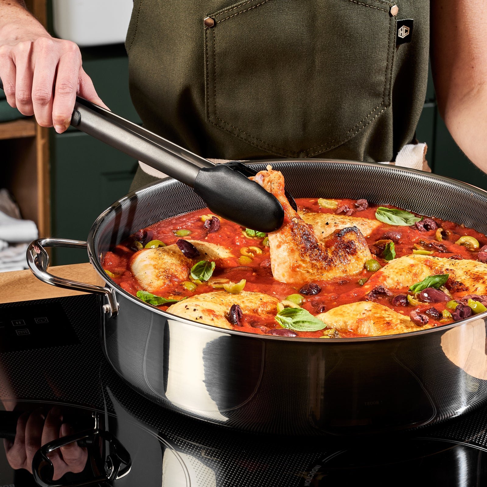 Golden chicken and vegetables cooking in a HexClad pan
